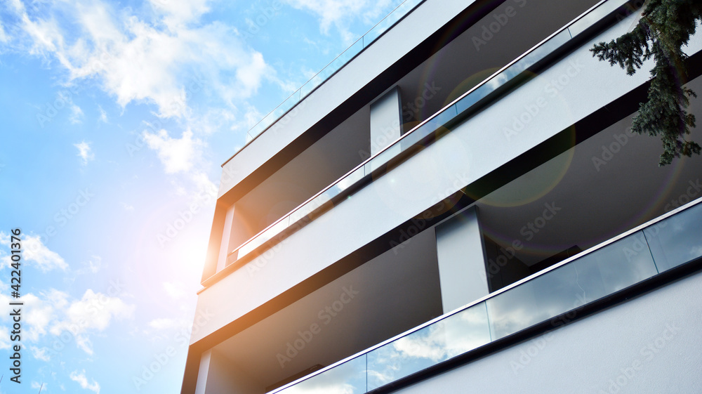 Image of condo on afternoon with sun set. Contemporary white residential building against a blue sky. Ideal for illustration of real estate or investment concepts. Image of condo on afternoon with sun set. Contemporary white residential building against a blue sky. Ideal for illustration of real estate or investment concepts.