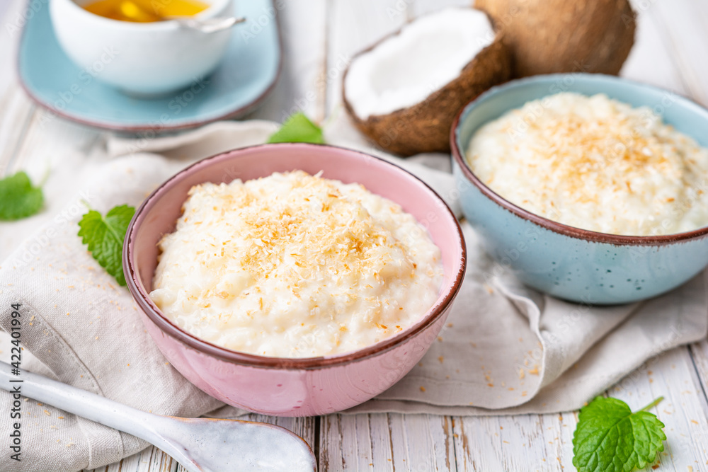 Sweet and creamy coconut rice pudding with honey, topped with grated and toasted coconut Sweet and creamy coconut rice pudding with honey, topped with grated and toasted coconut