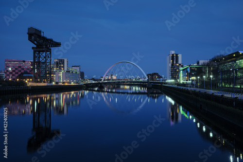 Night view of the Clyde Arc or Squinty Bridge from the East and river Clyde, Glasgow, Scotland