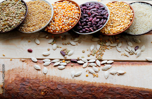 a beautiful assortment of legumes, lentils, rice, beans, corn, peas, barley. photo