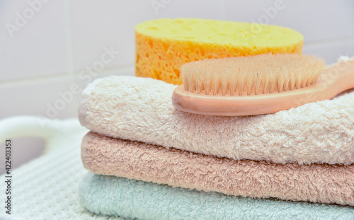 Stack of spa towels and bath brush