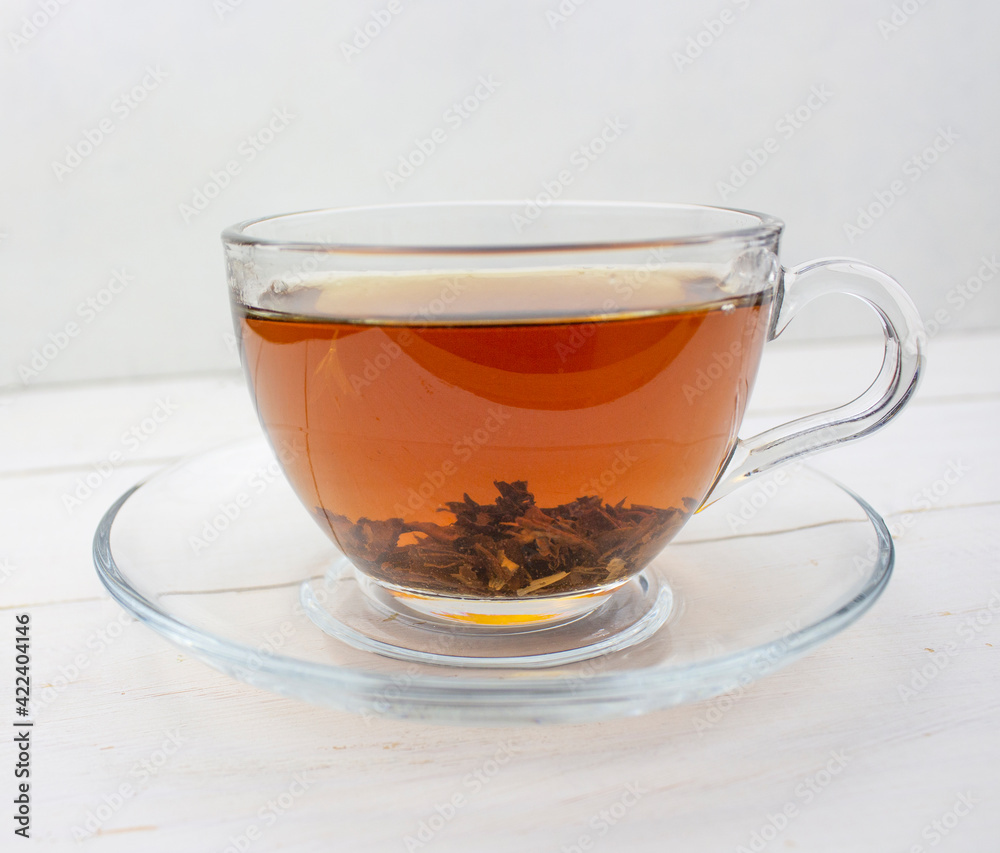 Tea. green Tea. Herbal tea. Mint leaf. Tea with apple flavor. Tea in a glass cup with apple blossoms and leaves dried tea sliced lime. herbs tea and mint leaves on a slate plate in a restaurant or tea Tea. green Tea. Herbal tea. Mint leaf. Tea with apple flavor. Tea in a glass cup with apple blossoms and leaves dried tea sliced lime. herbs tea and mint leaves on a slate plate in a restaurant or tea