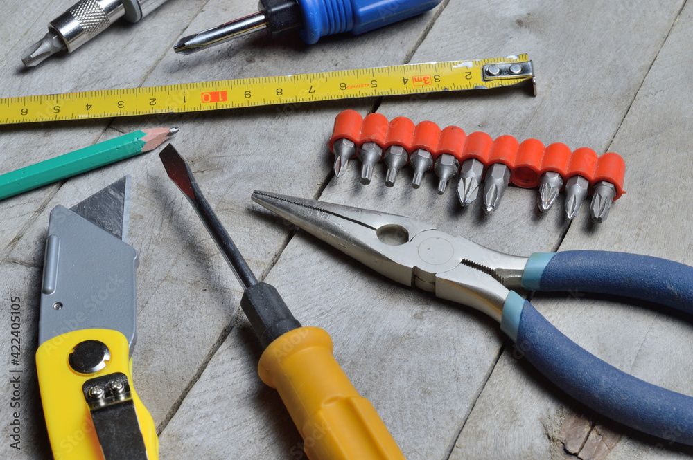 some home repair tools lie on a wooden background. close-up. some home repair tools lie on a wooden background. close-up.