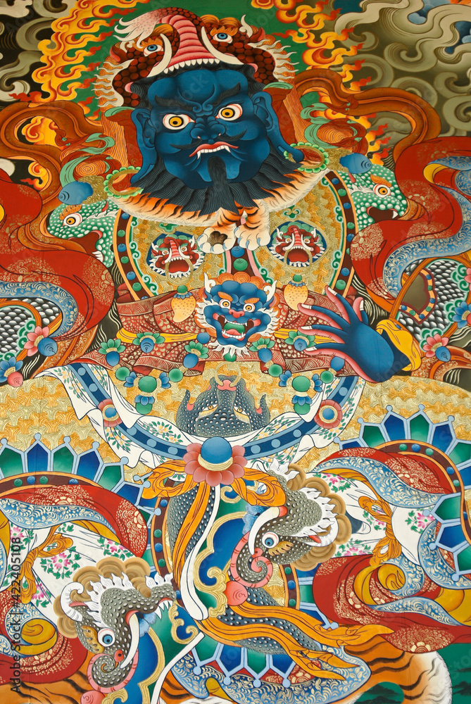 Fototapeta premium Colorful mural of a guardian deity at Songzanlin Tibetan Buddhist monastery, Shangri-la, Yunnan Province, China