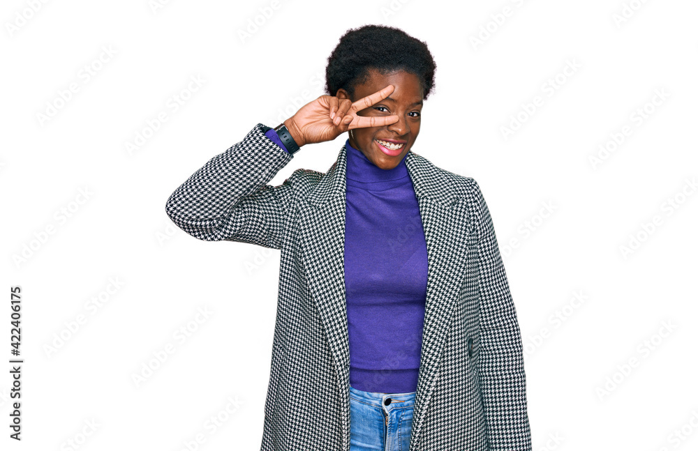 Young african american girl wearing casual clothes doing peace symbol with fingers over face, smiling cheerful showing victory Young african american girl wearing casual clothes doing peace symbol with fingers over face, smiling cheerful showing victory