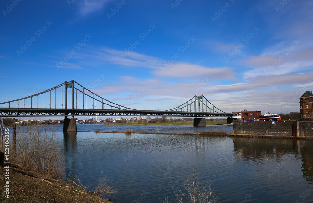 Krefeld (Ürdingen) - March 1. 2021:  View on old inland harbor with steel bridge over river rhine, industrial area background