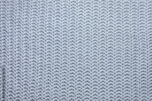 woolen background, texture of a knitted scarf or sweater, handmade knit, knitted background