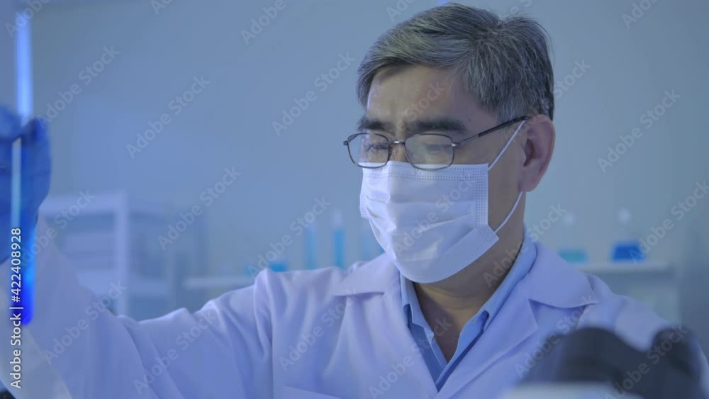 Research concept of 4k resolution. Asian scientists are comparing laboratory solutions.