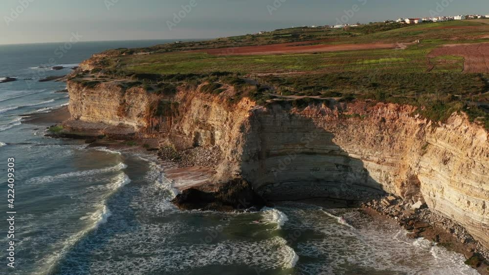 Aerial drone view of cape Cabo Espichel at sunset with cliffs and Atlantic ocean landscape. Western coast of Eurasia. Sesimbra, coastline of Portugal.
