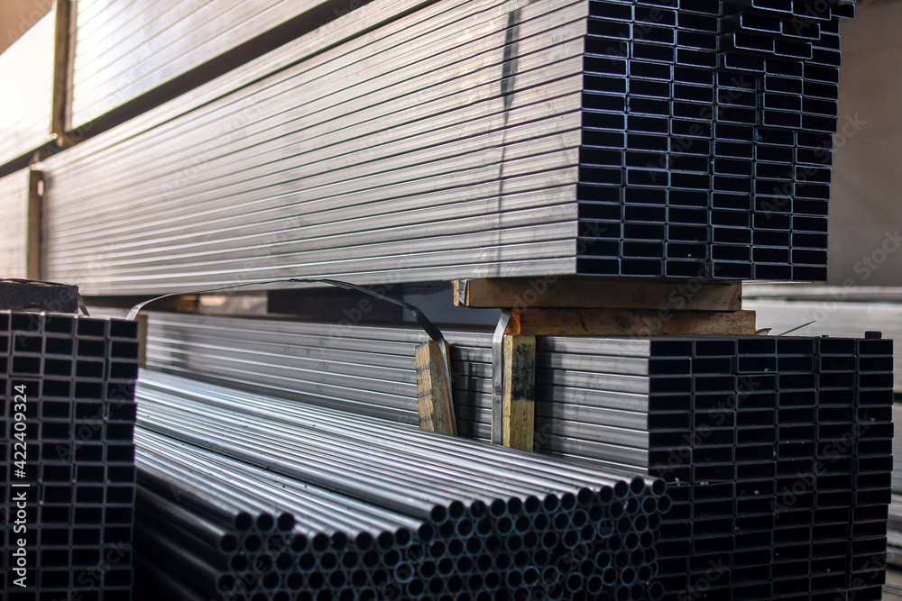 Obraz premium Stack of rectangular steel pipes for industrial background. Selective focus