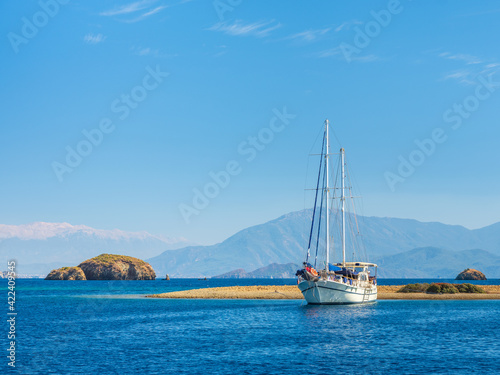 beautiful white sail yacht on the beach under blue sky in Turkey with copy space