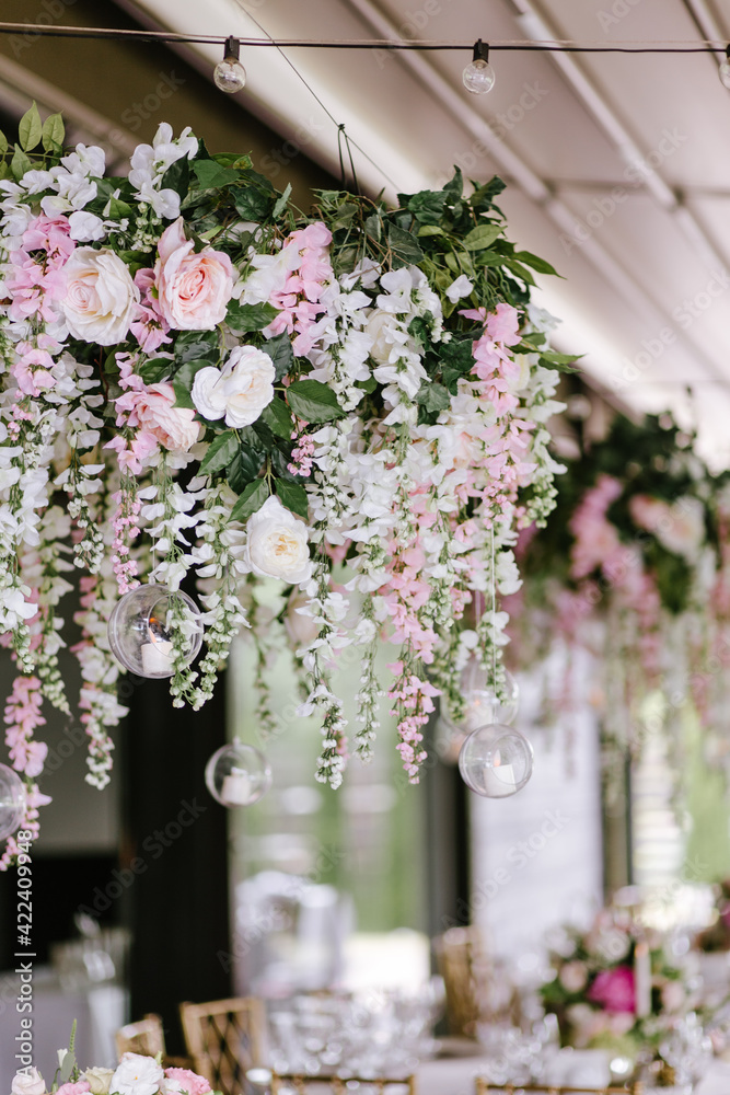 Fototapeta premium Close up of pink flower composition for wedding decoration. Decoration for wedding using candles and different nature flowers and leafs