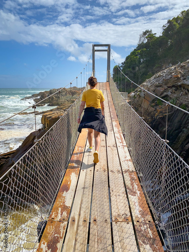 Woman on suspension bridge at Tsitsikamma National Park, South Africa. photo