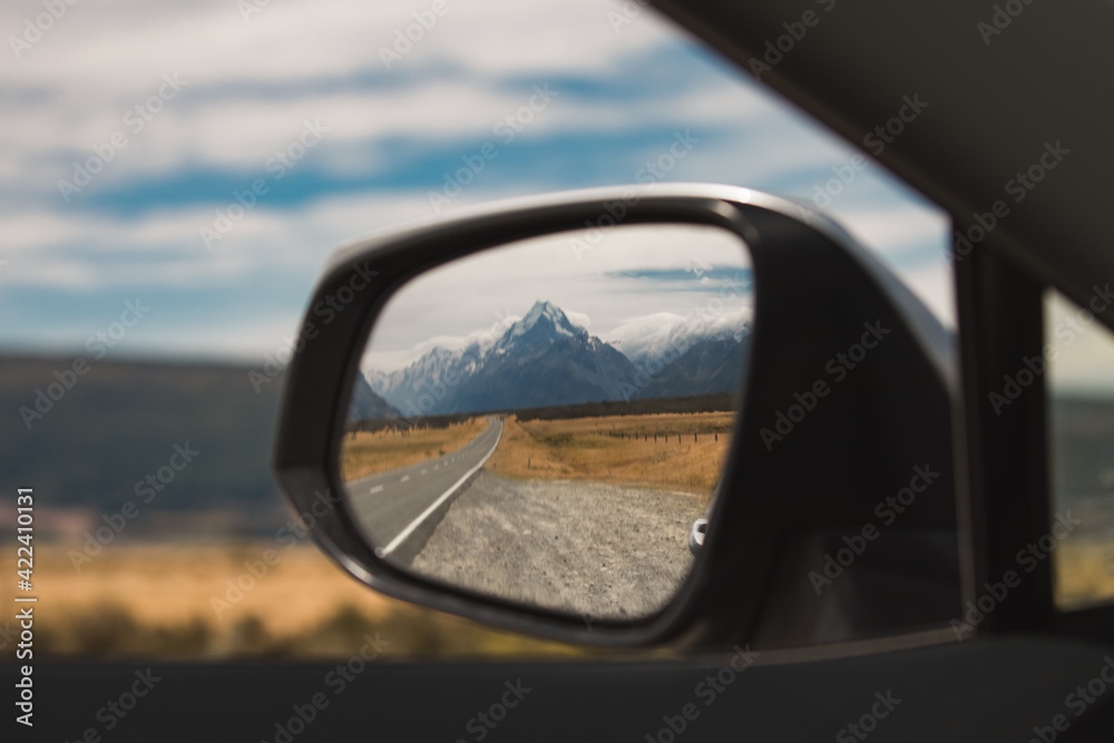 view of mount cook new zealand in the rear view mirror. end of journey. traveling is over view of mount cook new zealand in the rear view mirror. end of journey. traveling is over