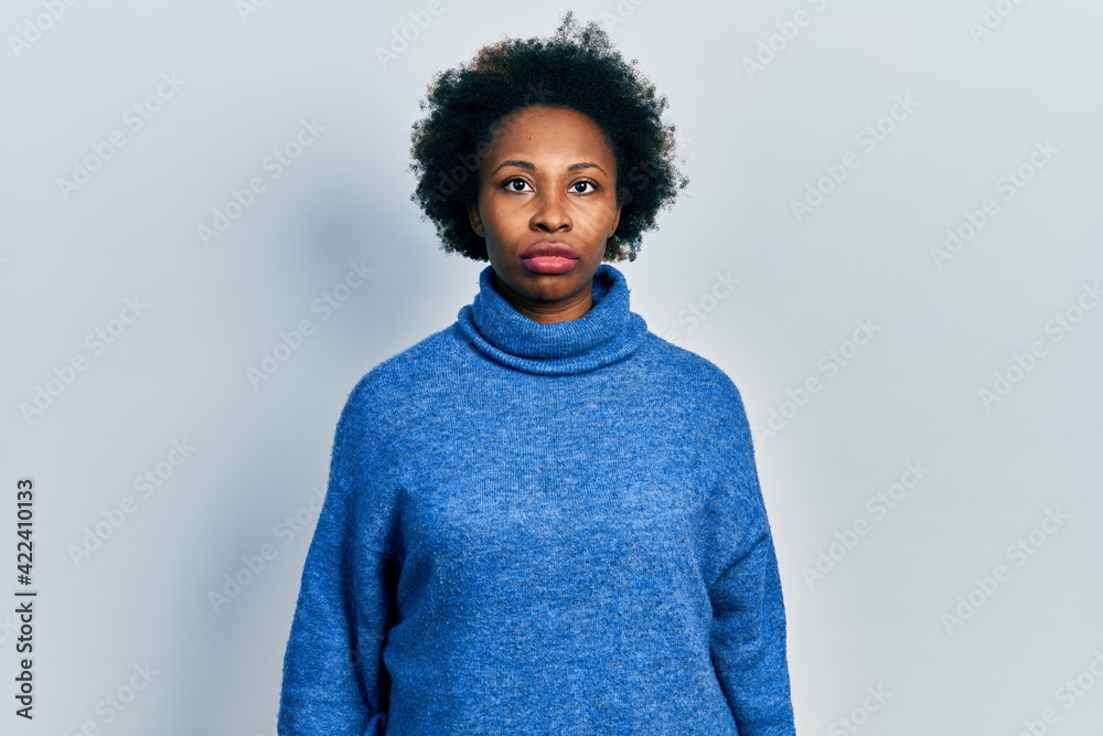 Young african american woman wearing casual clothes with serious expression on face. simple and natural looking at the camera.