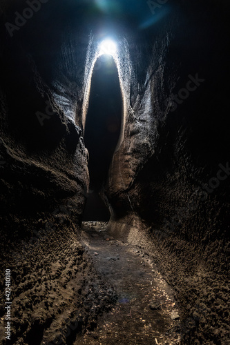 View from inside of Serracozzo volcanic cave on mount Etna, Italy