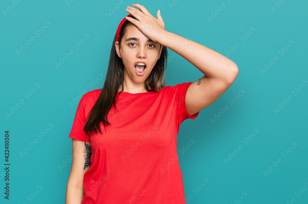 Young hispanic woman wearing casual clothes surprised with hand on head for mistake, remember error. forgot, bad memory concept. Young hispanic woman wearing casual clothes surprised with hand on head for mistake, remember error. forgot, bad memory concept.