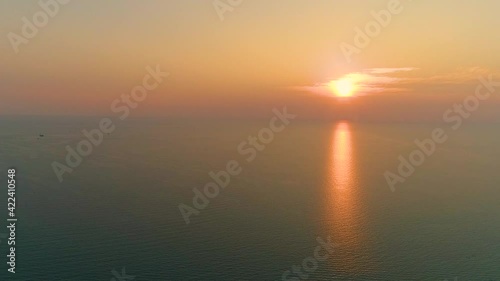 Aerial view from flying drone calm ocean at sunset
