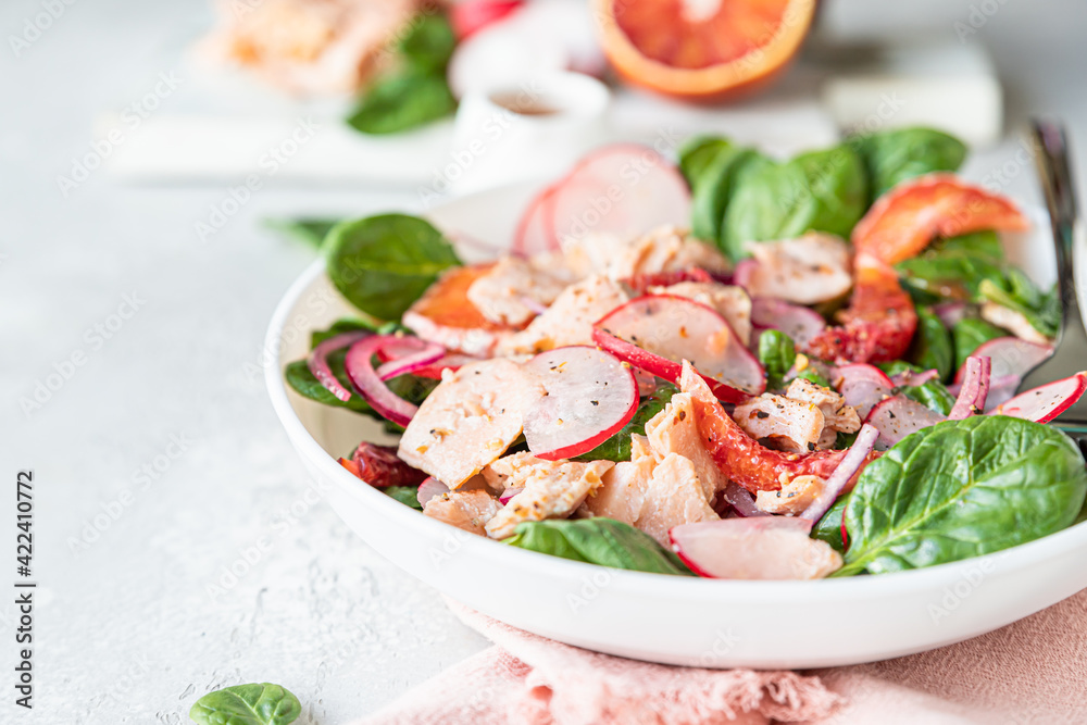 Salmon salad with orange, spinach and radish with ingredient for making salad on wooden cutting board. Healthy food. Salmon salad with orange, spinach and radish with ingredient for making salad on wooden cutting board. Healthy food.