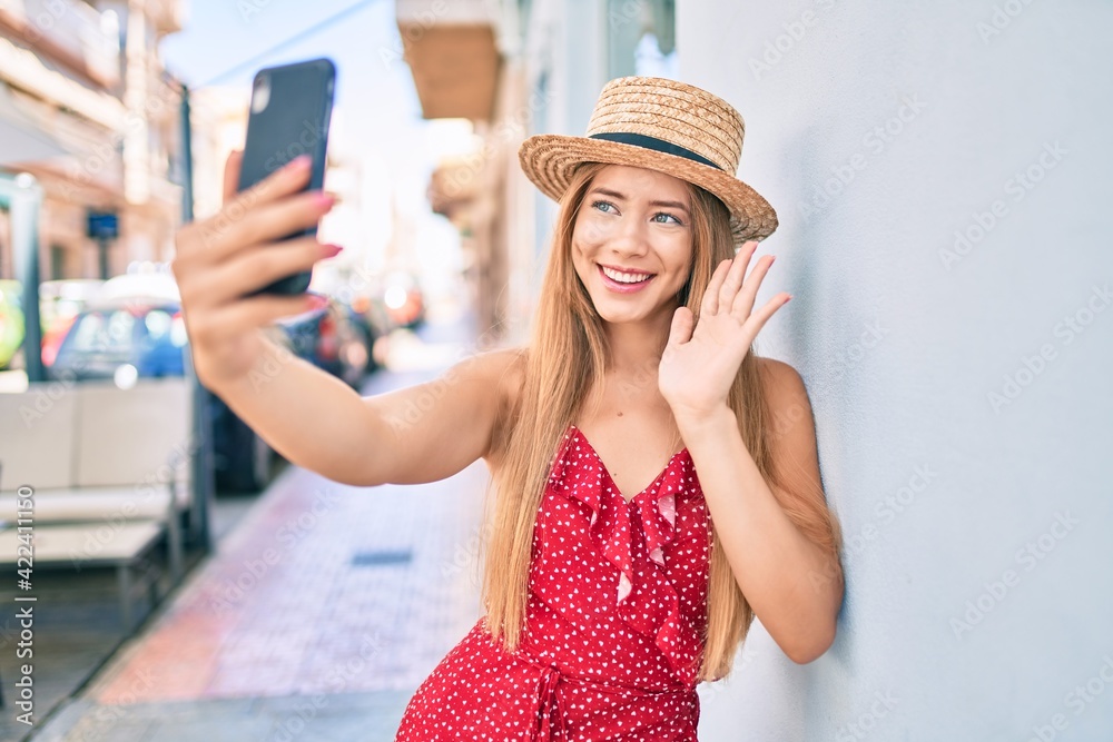 Young caucasian tourist girl smiling happy doing video call using smartphone at the city.