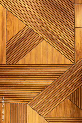 Fototapeta Naklejka Na Ścianę i Meble -  Designer walnut veneer panel, geometric crisscross pattern wood wall. Architectural background, texture. The concept is a modern interior, natural materials, minimalism style. Vertical