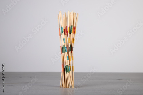 mikado game sticks, fallen down on a wooden board, motion blur