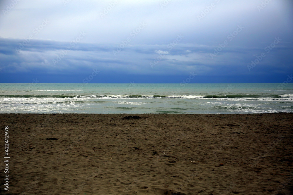 Layered horizontal view of the beach and stormy sea