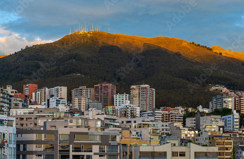 Skyline of modern apartment buildings in Quito with the Pichincha volcano at sunrise, Ecuador. © SL-Photography