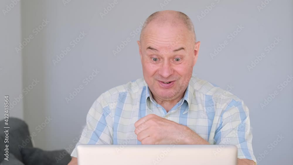 cheerful, crazy senor sits at home in front of computer, serves information on Internet, rejoices violently emotionally, shouts in euphoria, concept won the lottery, on stock exchange, satisfied cheerful, crazy senor sits at home in front of computer, serves information on Internet, rejoices violently emotionally, shouts in euphoria, concept won the lottery, on stock exchange, satisfied