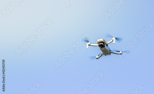 A drone flying outdoor, zoom photo, technology theme