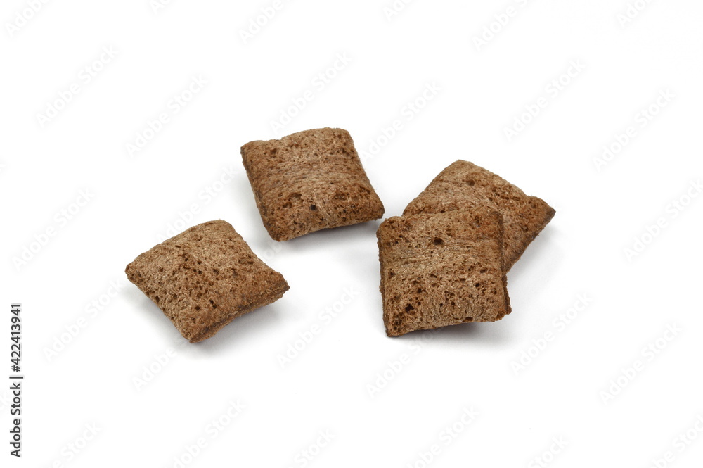 Heap of chocolate pillow cereals isolated on white background. Nougat filled chocolate pillow wafers pile isolated on white background. Crispy chocolate cereal pillow flakes. Heap of chocolate pillow cereals isolated on white background. Nougat filled chocolate pillow wafers pile isolated on white background. Crispy chocolate cereal pillow flakes.