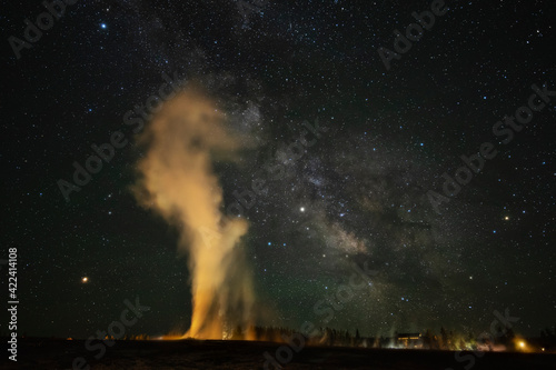 USA, Wyoming, Yellowstone National Park. Milky Way and erupting Old Faithful Geyser.