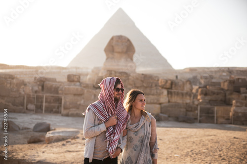 Young Couple in front of the Pyramids of Giza and the Sphinx  photo