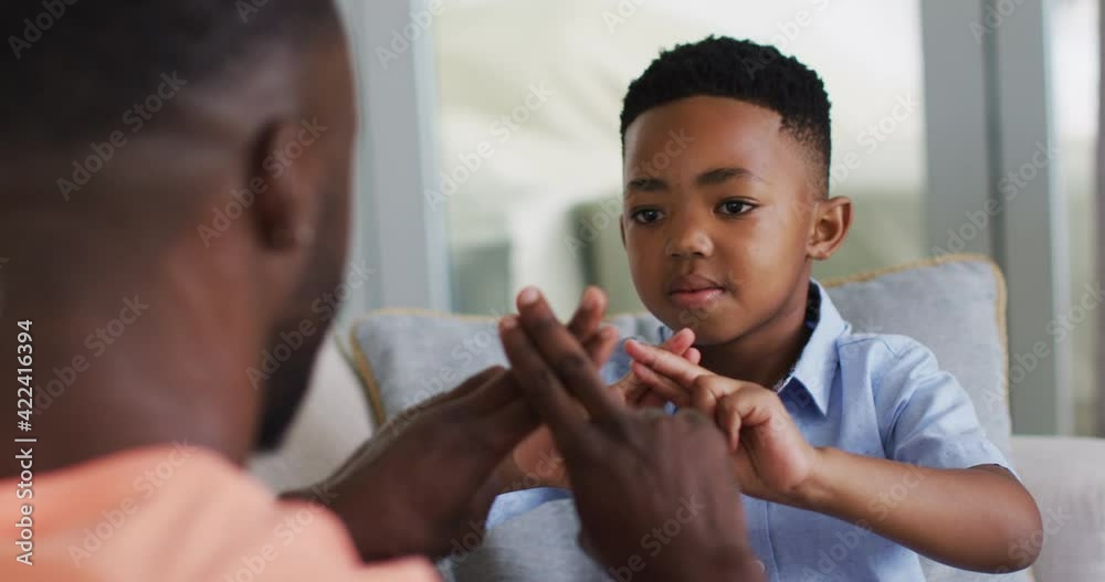 African american father teching his son sign language