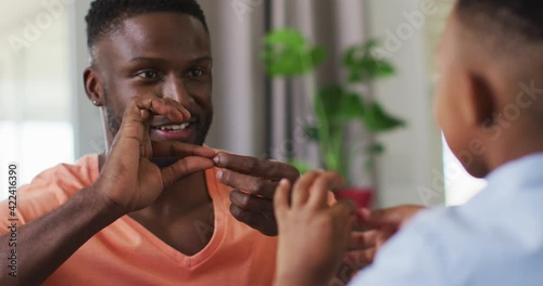 African american father teching his son sign language photo