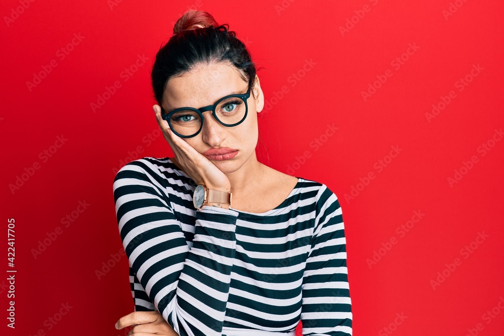 Young caucasian woman wearing casual clothes and glasses thinking looking tired and bored with depression problems with crossed arms. Young caucasian woman wearing casual clothes and glasses thinking looking tired and bored with depression problems with crossed arms.