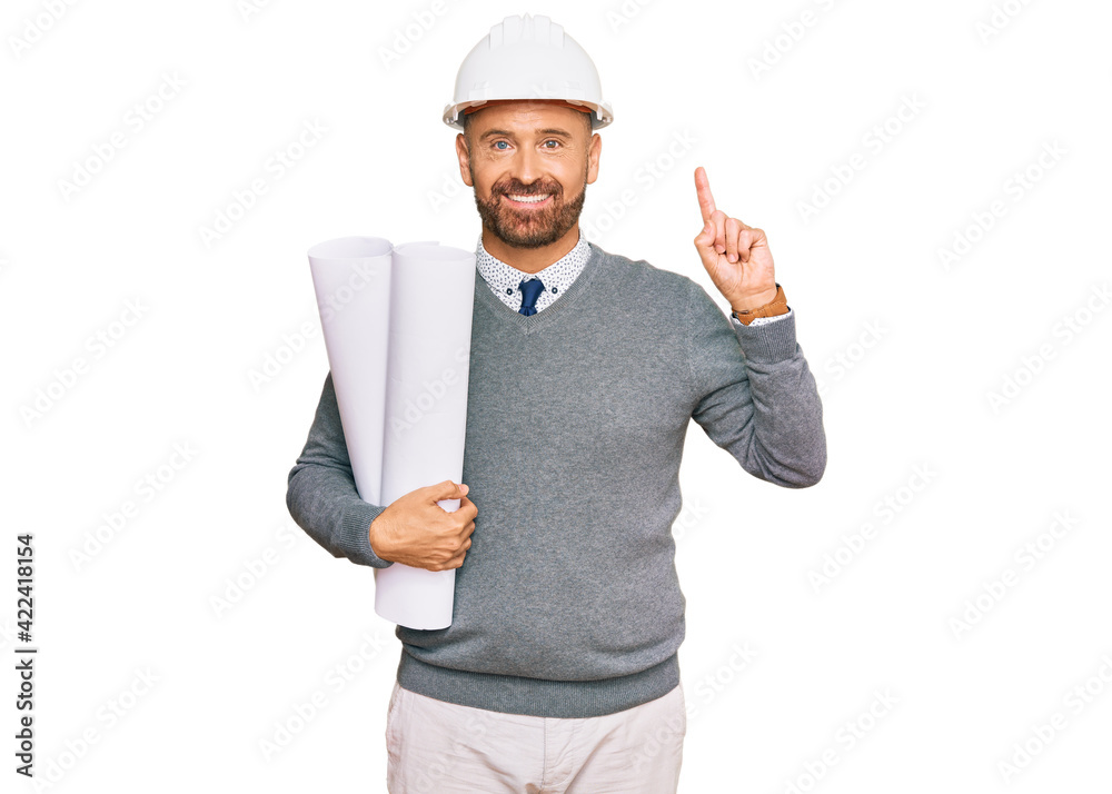 Handsome middle age man holding paper blueprints surprised with an idea or question pointing finger with happy face, number one Handsome middle age man holding paper blueprints surprised with an idea or question pointing finger with happy face, number one
