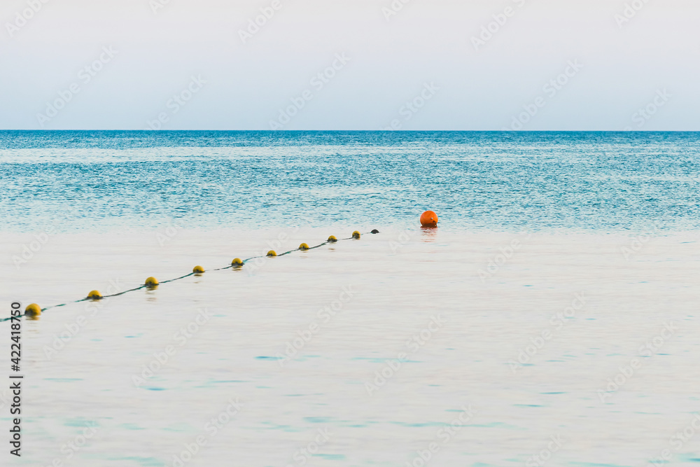 Limiting swimming buoys on the sea background in the evening Limiting swimming buoys on the sea background in the evening