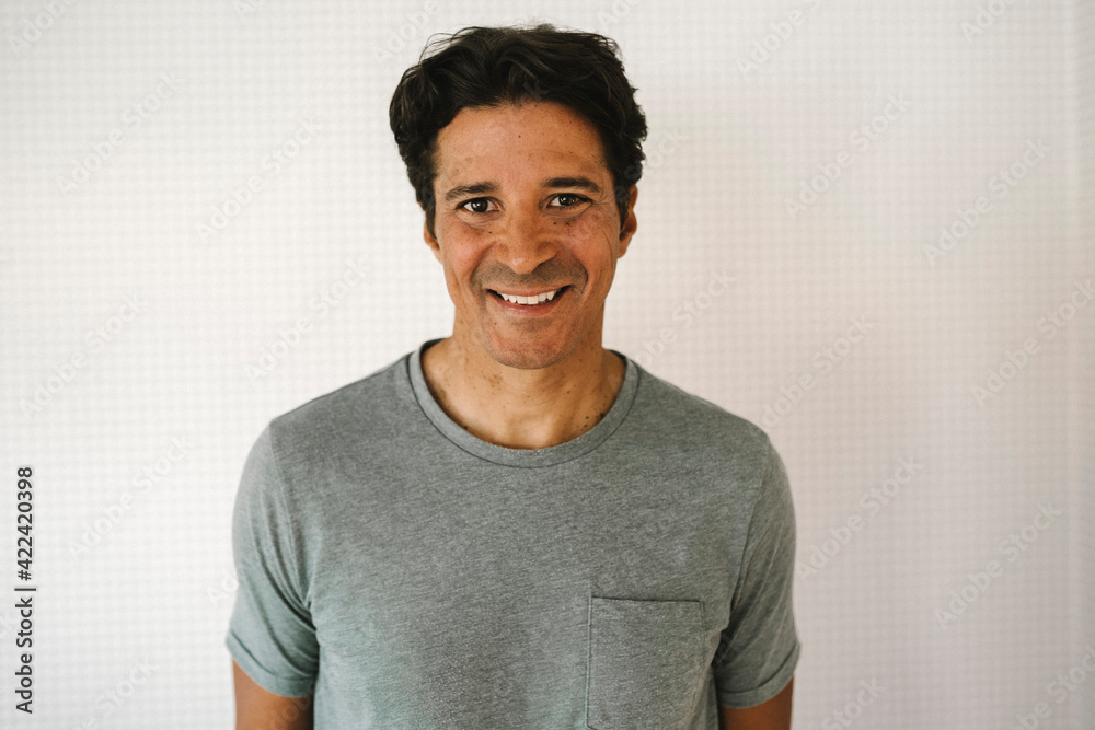Smiling mature man against white wall at home Smiling mature man against white wall at home