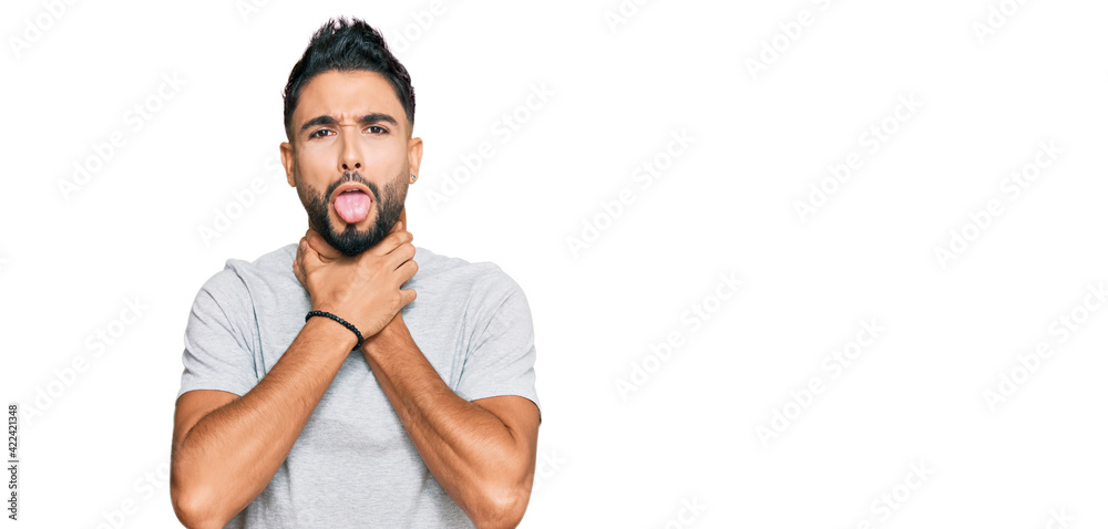 Young man with beard wearing casual grey tshirt shouting and suffocate because painful strangle. health problem. asphyxiate and suicide concept. Young man with beard wearing casual grey tshirt shouting and suffocate because painful strangle. health problem. asphyxiate and suicide concept.