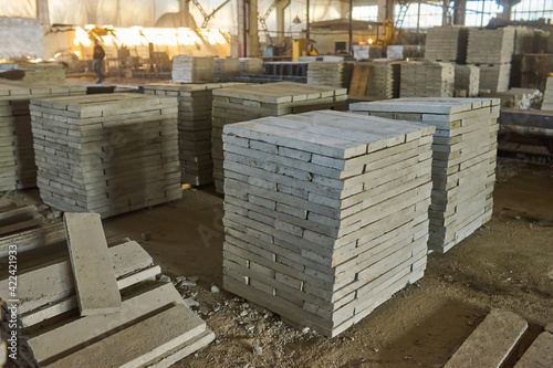 Paving slabs factory. Tiles piled in pallets.