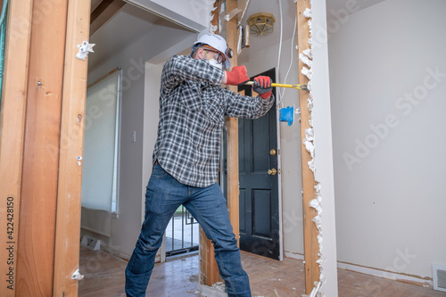 Contractor removing drywall