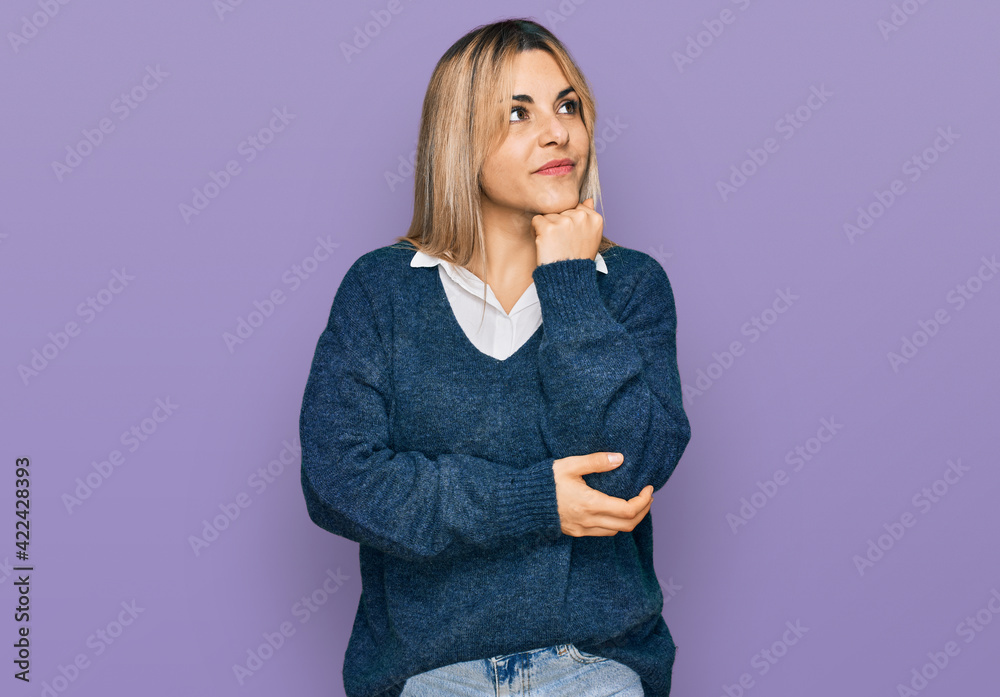 Young caucasian woman wearing casual clothes with hand on chin thinking about question, pensive expression. smiling and thoughtful face. doubt concept. Young caucasian woman wearing casual clothes with hand on chin thinking about question, pensive expression. smiling and thoughtful face. doubt concept.