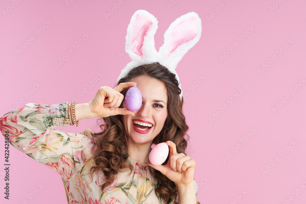 young woman in floral dress on pink young woman in floral dress on pink