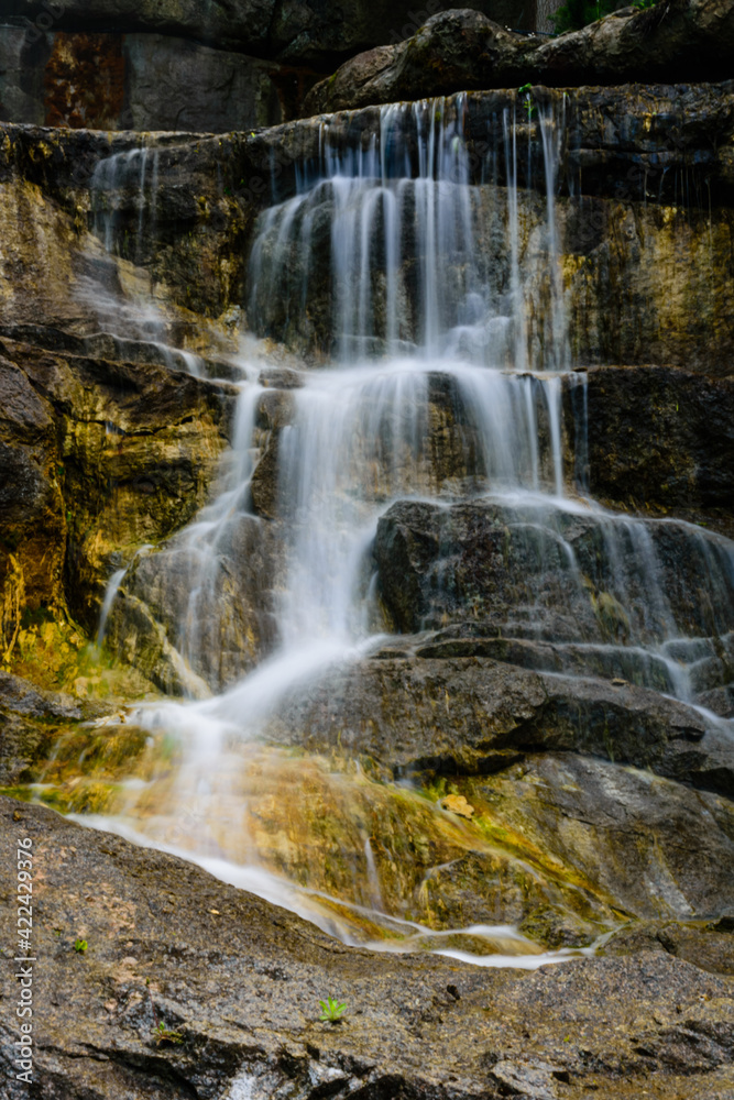 Beautiful waterfall on small river in a park Beautiful waterfall on small river in a park