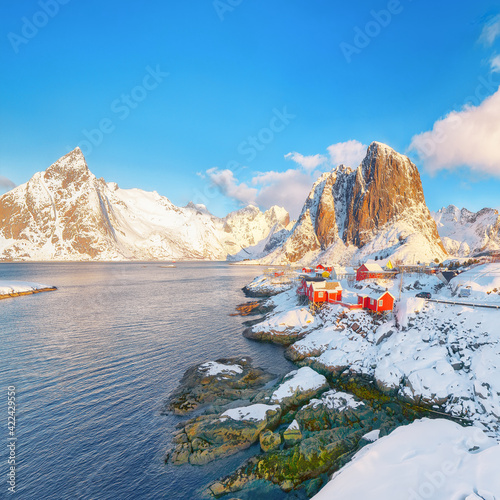 Picturesque winter view on Hamnoy village and Festhaeltinden mountain on background.
