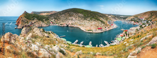 Panoramic view of Balaklava bay with yachts and ruines of Genoese fortress Chembalo in Sevastopol city from the height
