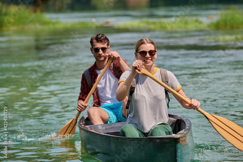 friends are canoeing in a wild river