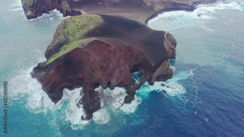 Capelinhos Volcano, Faial Island, Azores, Portugal. Aerial view of steep cliffs washed with blue ocean waters. The magnificent natural heritage with volcanic cliffs. High quality 4k footage photo