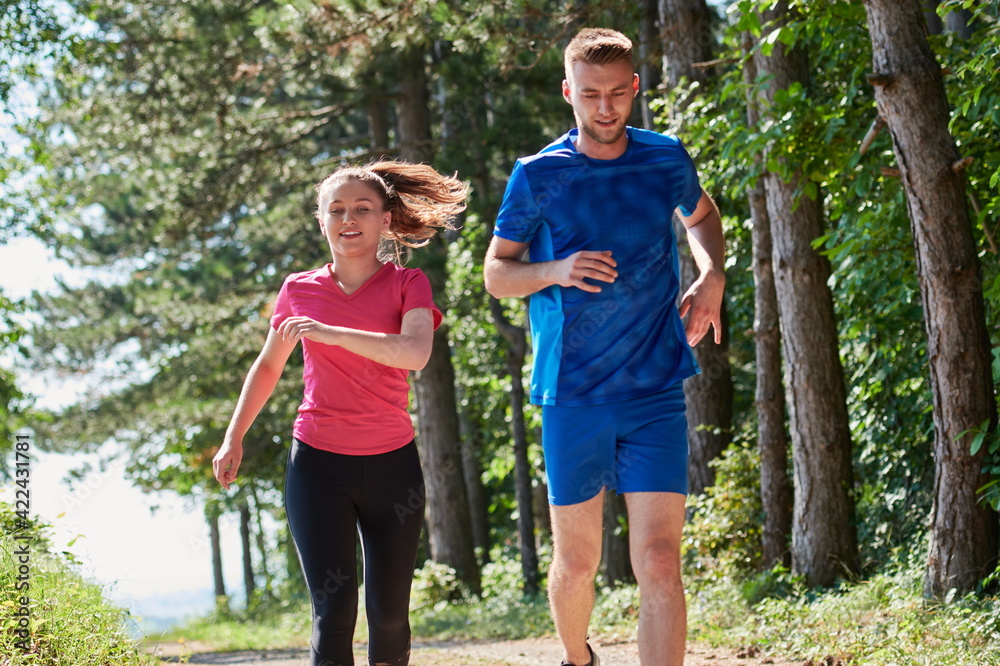 Fototapeta premium couple enjoying in a healthy lifestyle while jogging on a country road